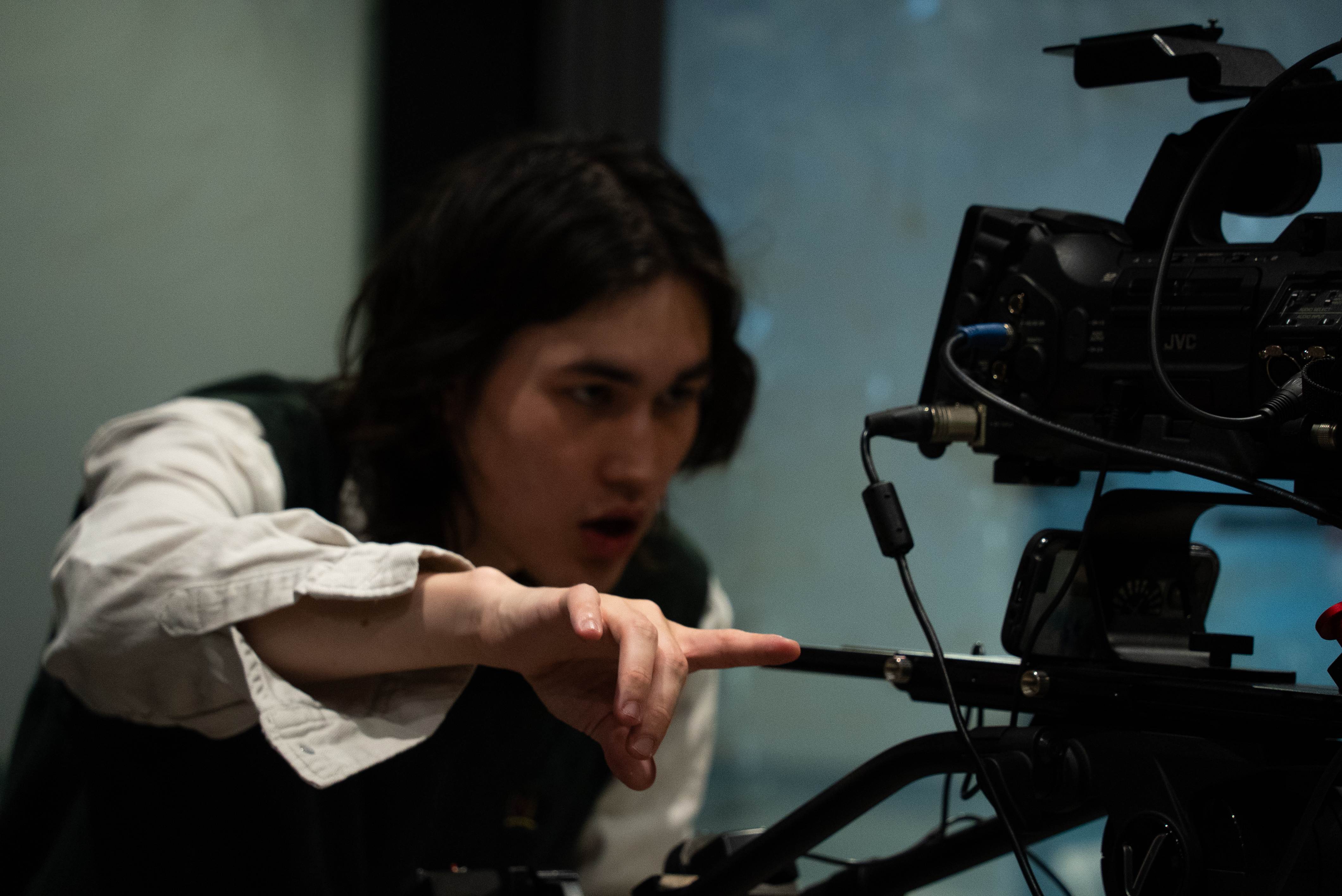 Camera operator filming a production setup